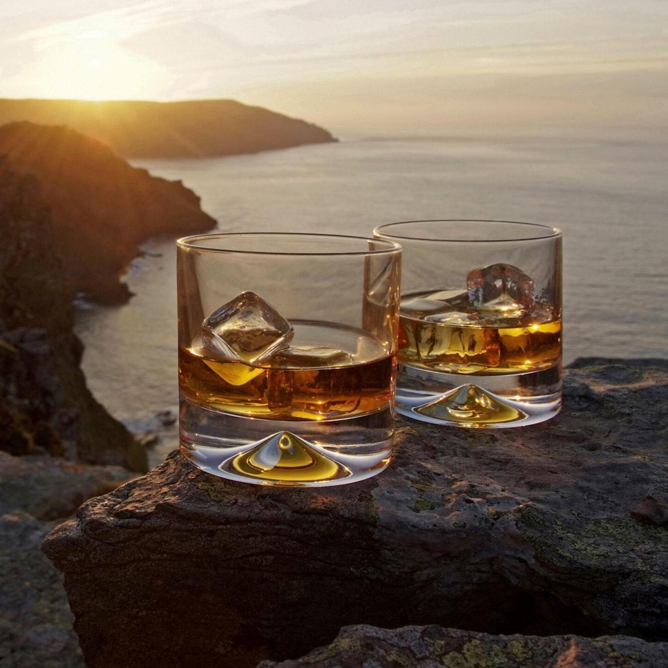 Dartington Crystal Case Study - Glasses on a table with a sea view